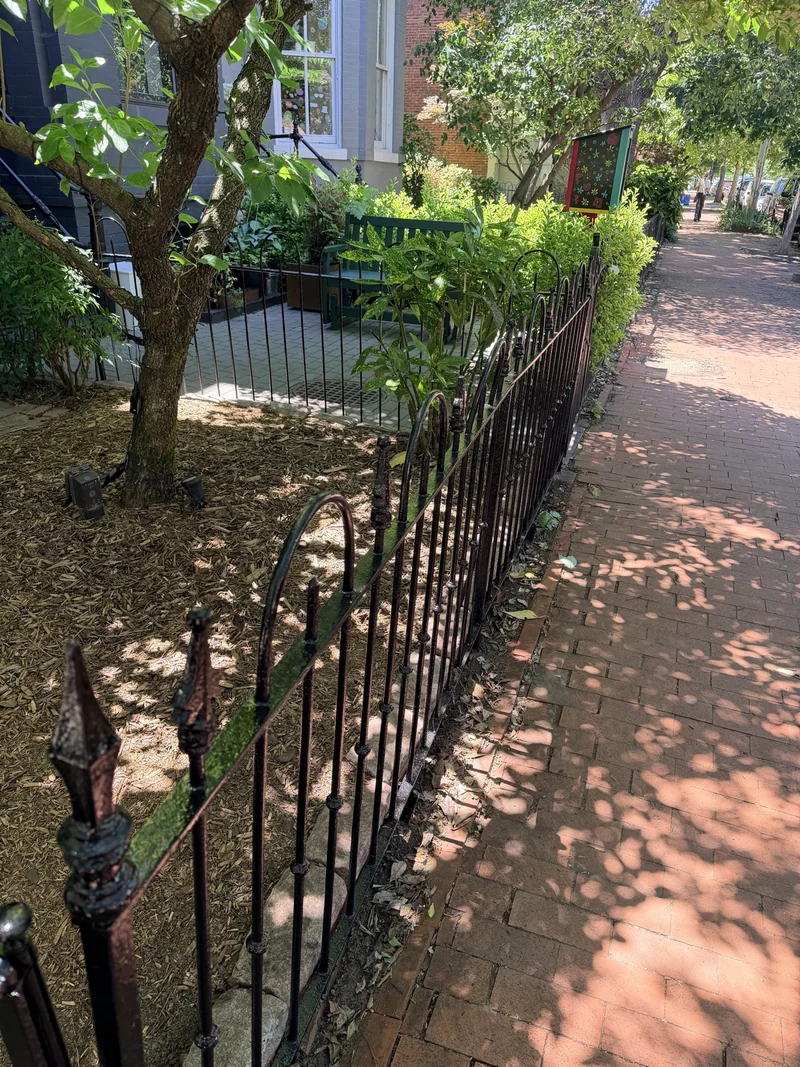 The same Capitol Hill sidewalk fence after restoration